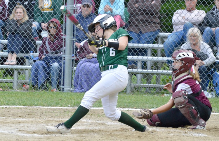 Winthrop's Hanna Caprara follows through on a swing while Monmouth catcher Abby Ferland anticipates the incoming pitch during the Ramblers' win in a Class C South quarterfinal Thursday in Winthrop.