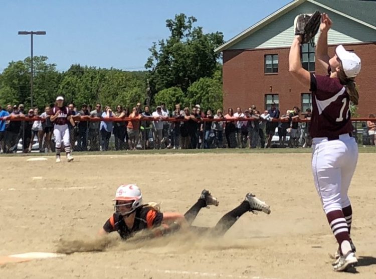 Edward Little first baseman Anna LeBlanc catches a pop fly as Skowhegan runner Mariah Dunbar dives back into first base during a Class A North semifinal Saturday in Skowhegan.