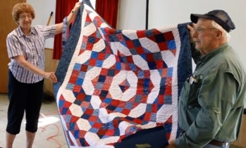 Jane Wilcox of the Maine Mountain Quilters of Farmington, left, recently presented a Quilt of Valor to Maj. Don Taylor during a meeting of the disabled veterans group called Back in the Maine Stream,