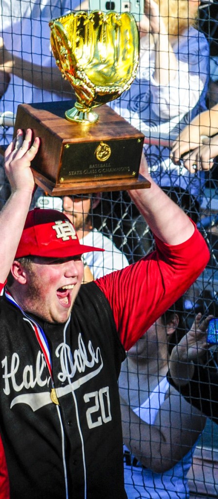 Hall-Dale pitcher Cole Lockhart celebrates with the Class C state championship trophy Saturday afternoon at St. Joseph's College.