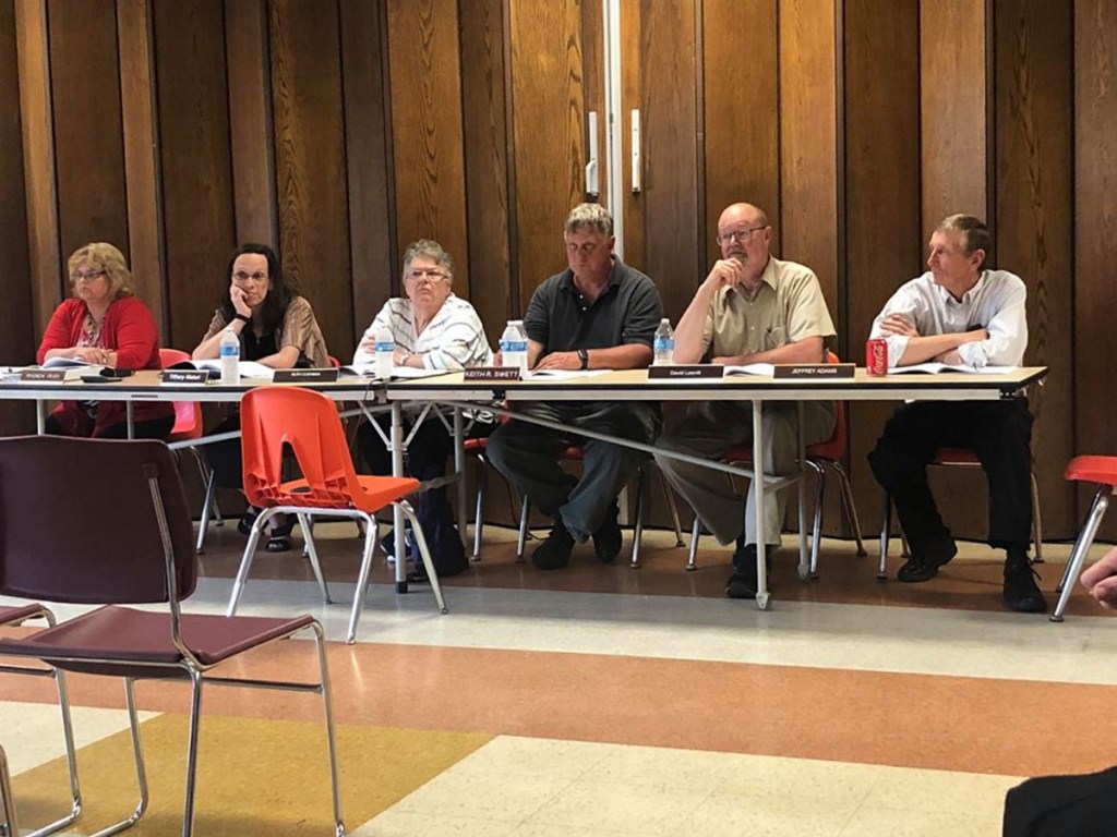 From left, Town Manager Rhonda Irish, Chairwoman Tiffany Maiuri, select board members Ruth Cushman, Keith Swett, David Leavitt, and Jeff Adams at the Wilton annual Town Meeting Monday night.