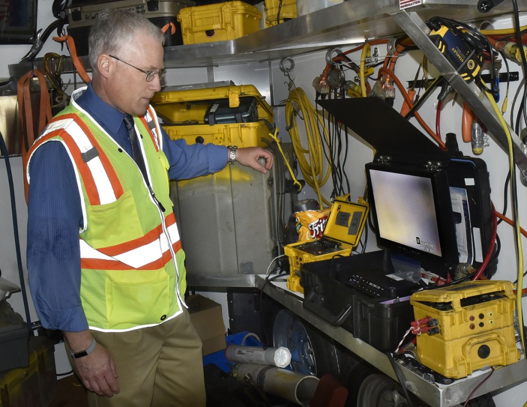 Roger Crouse, general manager of Kennebec Water District, monitors a hard-hat diver making repairs to an underwater 16-inch water line Tuesday in murky Messalonskee Stream off North Riverside Drive in Waterville. The line broke Monday, stirring up sediment in the pipes, causing discoloration in the water, which nevertheless is safe to drink and use, according to the Kennebec Water District.