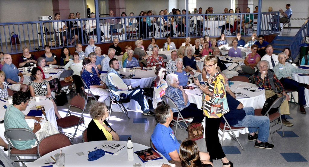 Dr. Carolyn Lukensmeyer, standing, was keynote presenter during the 32nd annual Thomas Nevola MD Symposium on Civil Discourse on Tuesday at Colby College in Waterville.