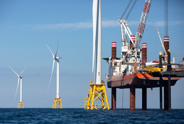 In this Aug. 15, 2016 file photo, A lift boat, right, that serves as a work platform, assembles a wind turbine off Block Island, R.I., in 2016. Officials in Massachusetts announced in May that Danish energy investor Copenhagen Infrastructure Partners and Avangrid Renewables, part of the Spanish company that owns Central Maine Power, had been selected to build the country’s first large-scale offshore wind project off Martha's Vineyard. 