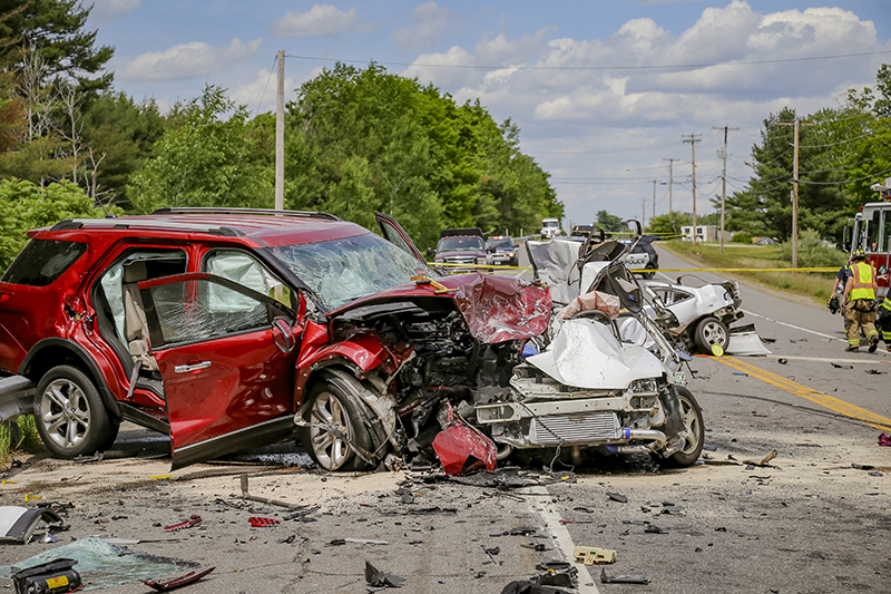 Firefighters and police work the scene of a multi-fatal car accident on Saturday afternoon J on Portland Street in Berwick.