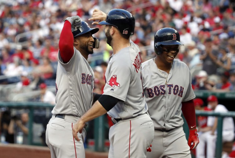 Boston's Eduardo Nunez, left, celebrates knocking in Mitch Moreland and Rafael Devers with a three-run homer in the second inning Tuesday night in Washington.