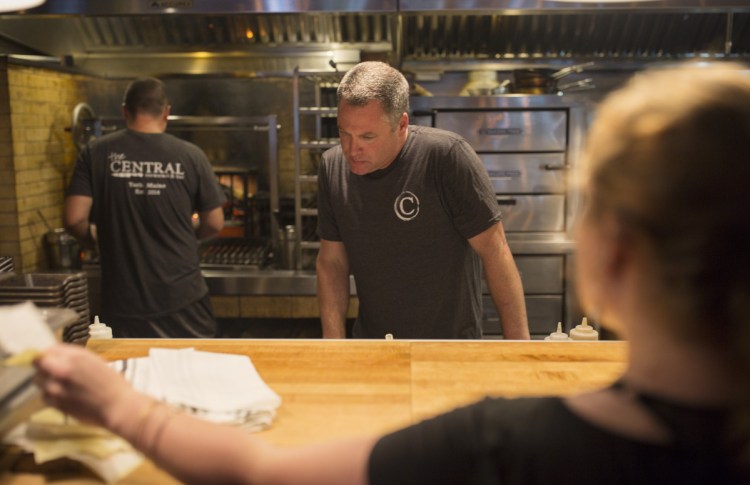 Ernst looks over tickets in the restaurant's open kitchen.