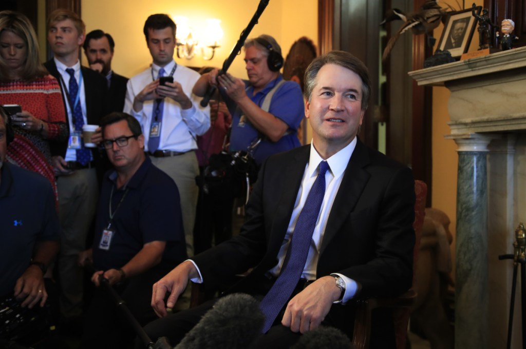 Supreme Court nominee Brett Kavanaugh listens to Sen. Rob Portman, R-Ohio, on Capitol Hill during a meeting Wednesday.