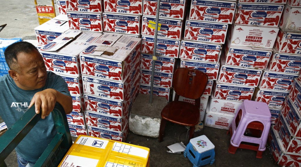 A man waits to pick up goods at an imported seafoods dealer in Beijing. The U.S. plans to expand tariffs on Chinese imports.