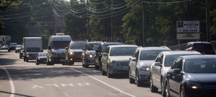 Traffic backs up Friday during morning rush hour on Broadway at Evans and Lincoln streets, a bottleneck that carries about 24,240 vehicles daily.