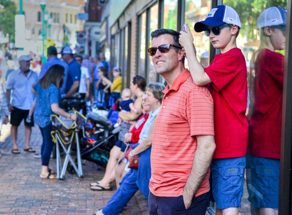 Andrew Bond, left, stands with his son, Sebastian Bond, as he records Great Race vehicles arriving June 26 in Gardiner.