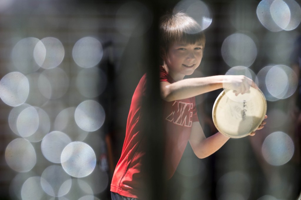 Nate Delisle, 11, of Poland, practices his short game during a Pro Disc Golf Association qualifier at Burnsboro Disc Golf Course on Saturday in Vassalboro.