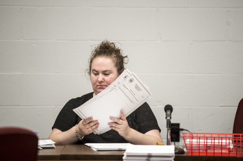 Tanya Going, acting town clerk for the town of Winslow, counts ballots Tuesday at the Town Office that were cast to decide the $8.1 million school bond, which voters passed 881-825 on June 12. Phil St. Onge, an opponent of the bond, said he is concerned that on 194 ballots the question was left blank and forced the recount as a way to inspect the ballots.