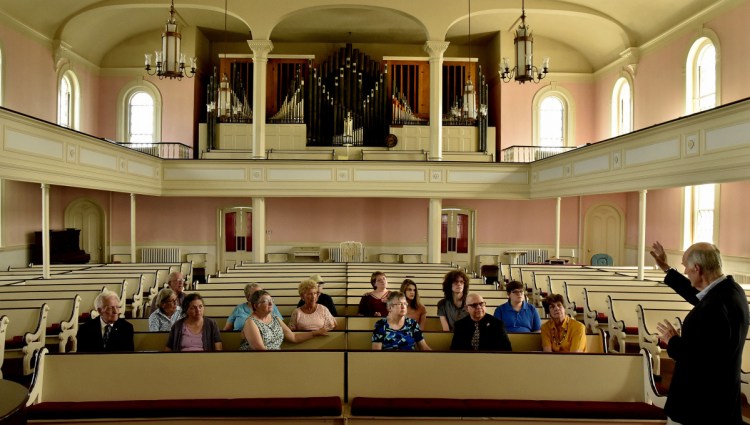 First Baptist Church member Sam Goddard conducts a tour of the church in Waterville for the 200th anniversary celebration on Sunday.