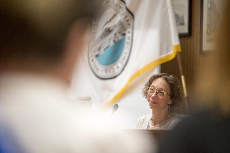 Lauren Lessing, of Ward 3, listens to commenters during community notes at a city council meeting at the city council chambers in Waterville on July 3.