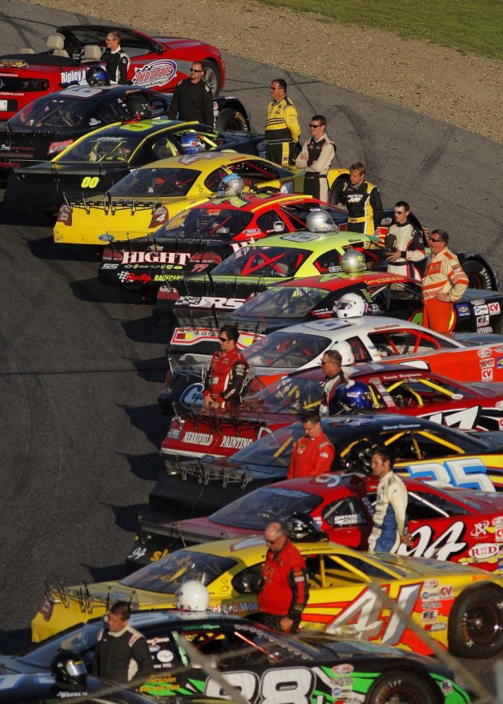 Portland Press Herald file photo by Gabe Souza 
 Drivers stand by their vehicles before the start of the National Anthem for the 40th running of the Oxford 250 on July 21, 2013.