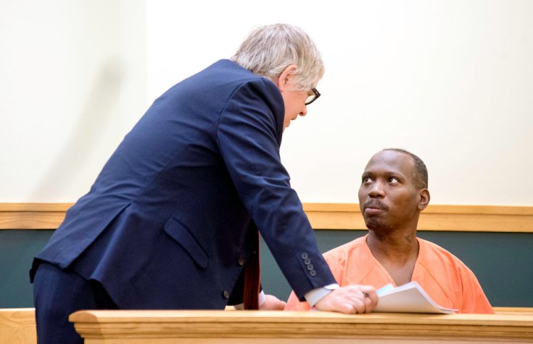 James Crump, right, talks with his attorney James Howaniec in Lewiston District Court on Monday. (