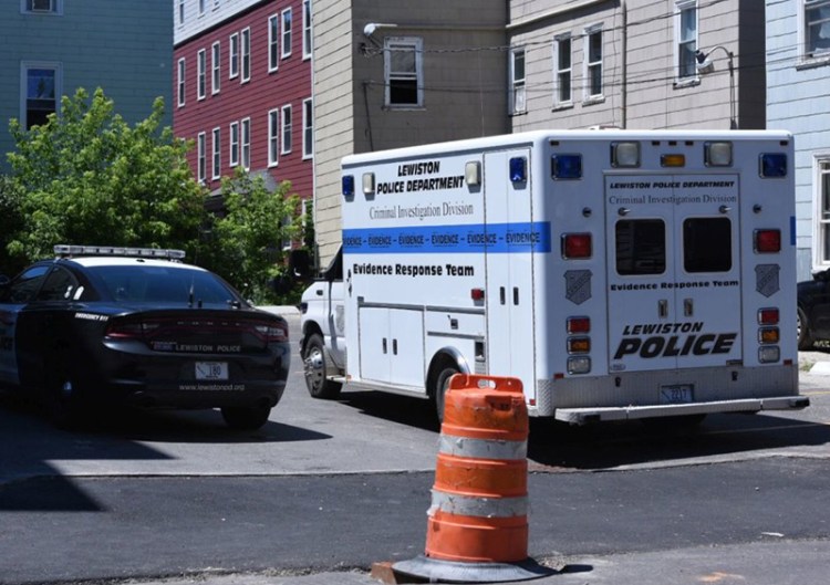 Police remain at the scene Saturday afternoon after an early morning shooting on Bartett Street in Lewiston. 
