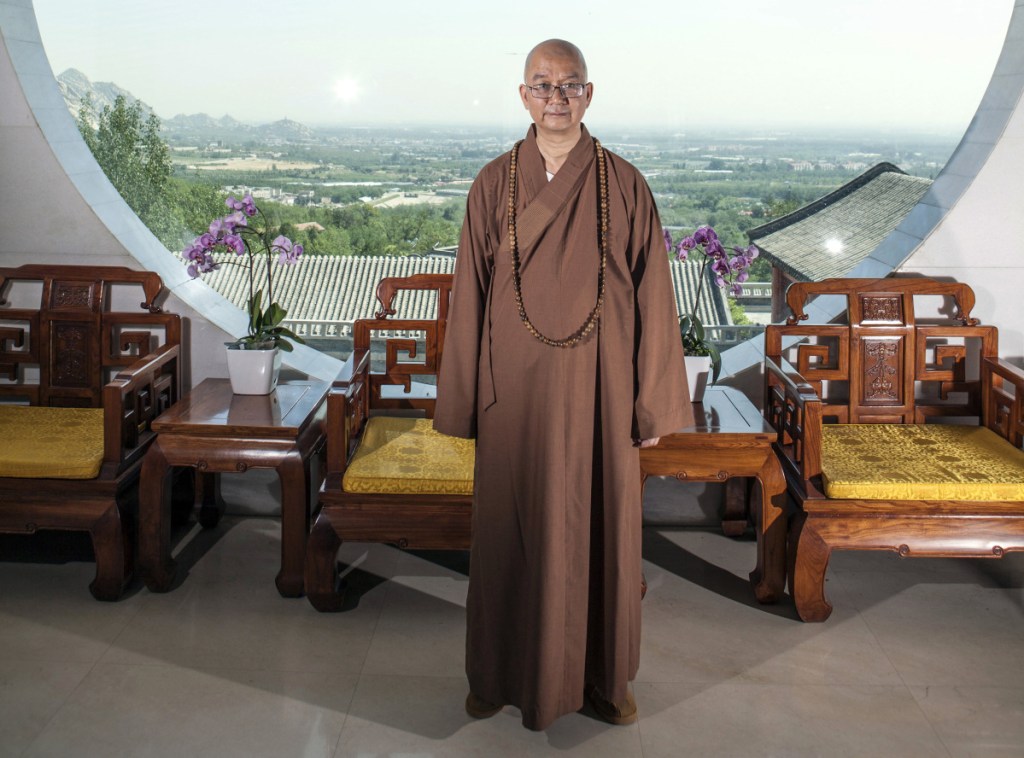 In this photo taken July 3, 2015, Abbot Xuecheng of the Beijing Longquan Temple poses for a photo in one of the temple buildings in Beijing, China. Xue, one of China's highest-ranking Buddhist monks is facing a government investigation over accusations of sexual misconduct, in what is seen by some as an indication the #MeToo movement is gaining traction in the world's most populous nation.