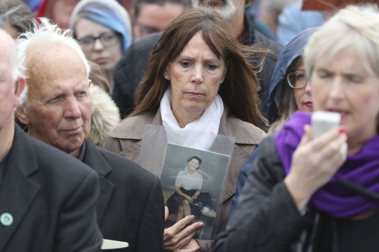 A protester on Sunday holds up the name of a baby whose remains were among hundreds found in a mass grave at the site of the former church-run Tuam home.