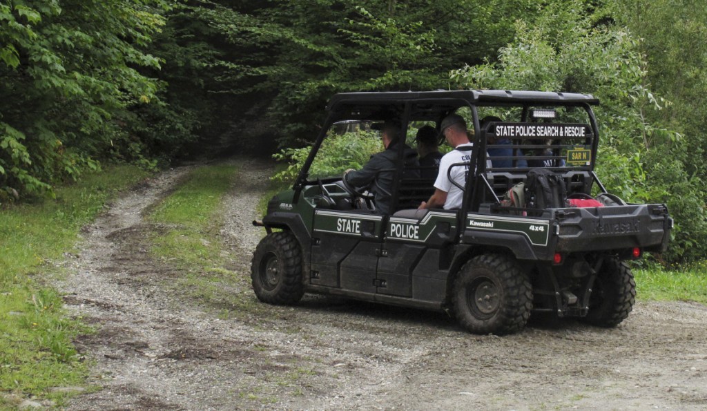 Recovery crews head into the woods of Vermont's Sterling Mountain, Thursday, in Morristown, Vt., to help transport out the bodies of three people killed in a glider crash.