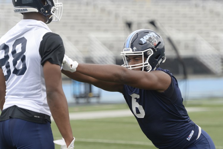 Sterling Sheffield runs drills during the first day of training camp for UMaine football Wednesday in Orono.