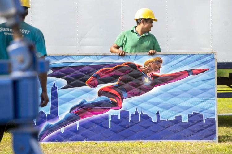 Antonio Hernandez sets up a portion of the Sky Diver ride as crews get ready for the 200th annual Skowhegan State Fair at the Skowhegan Fair Grounds on Wednesday.