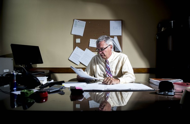 Superior Court Justice Robert Mullen reviews juror paperwork in his chambers at the Somerset Superior Court on Friday. Mullen has summoned a dozen jurors to the courthouse on Tuesday who failed to show up for a recent jury call. "The law is the law and I think some people need to realize that there are some teeth to back up their duty to serve if they don't come and don't explain why," he said.