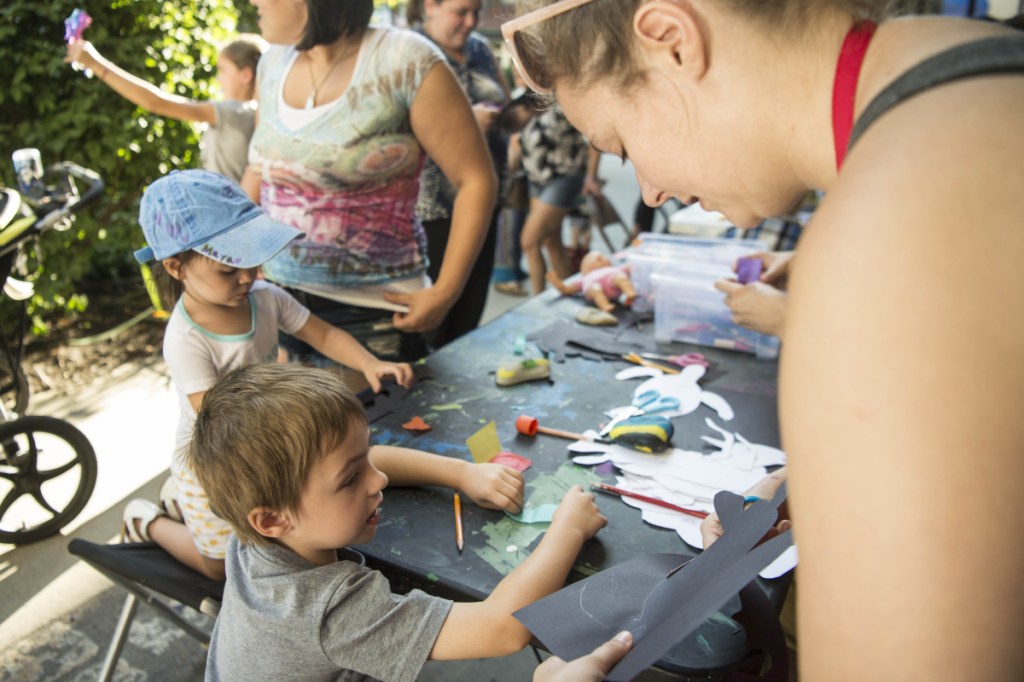CJ Bernardini, 4, gets help on his art project Thursday from Dianna Wendell, right, at Common Street Arts at The Center at Castonguay Square in downtown Waterville. Waterville Creates! and Common Street Arts are moving temporarily to the Hathaway Creative Center to make way for long-term changes at The Center on Main Street.