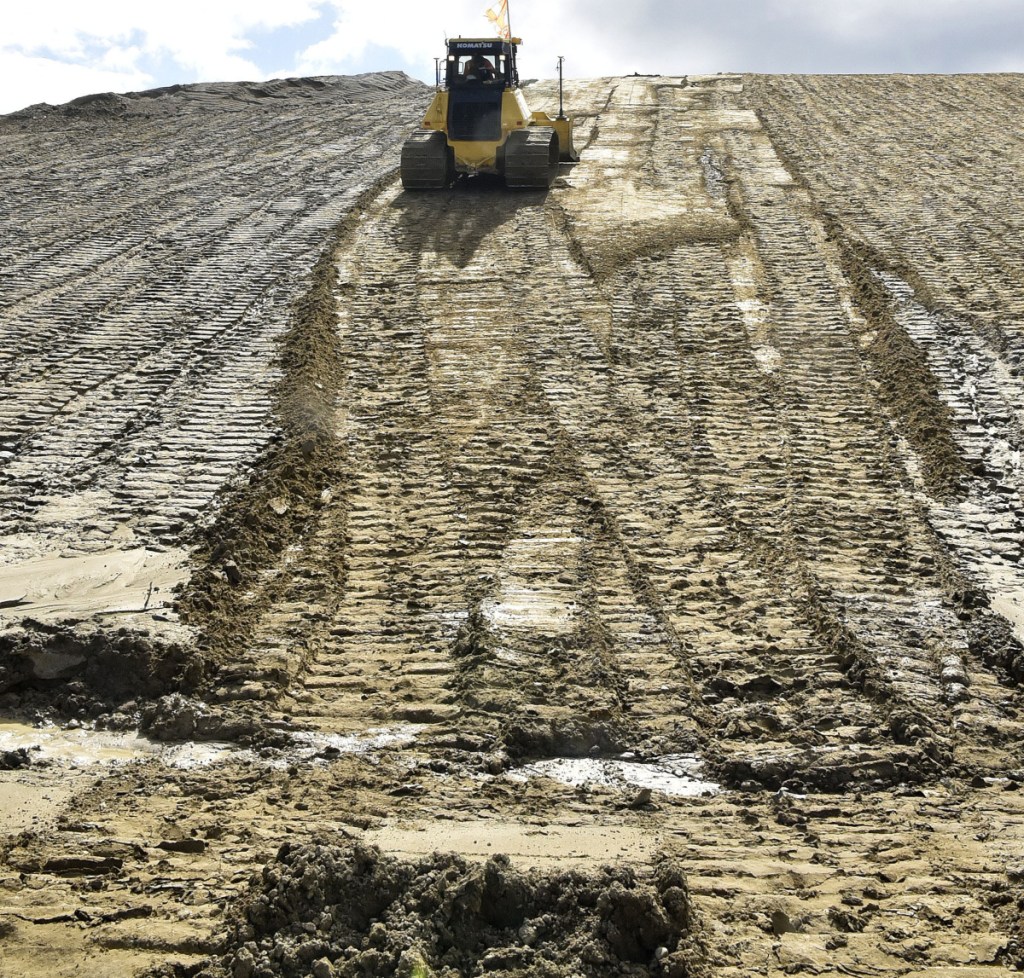 A bulldozer operator caps a landfill section that is at capacity Thursday at Waste Management's 933-acre Crossroads facility in Norridgewock. Waste Management is proposing to expand the landfill by 51 acres on land it owns, upgrade the transfer station used by nine towns, and increase waste reduction and recycling by adding a textile recycling program and a composting program.