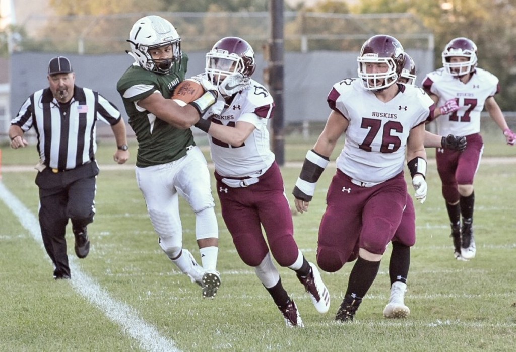 Maine Central Institute defender Will Russell pushes Leavitt running back Dasean Calder out of bounds during the first quarter of a Class C game Friday night at Libby Field in Turner.