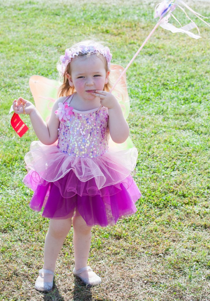 After winning the costume contest at Sunday's Farmington Fair, Cordelia Murphy, 3, of Sumner tries to decide where to go next.