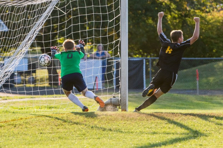 Maranacook's Aric Belanger celebrates after scoring on Mt. Blue goalie Xander Gurney on Tuesday in Readfield.