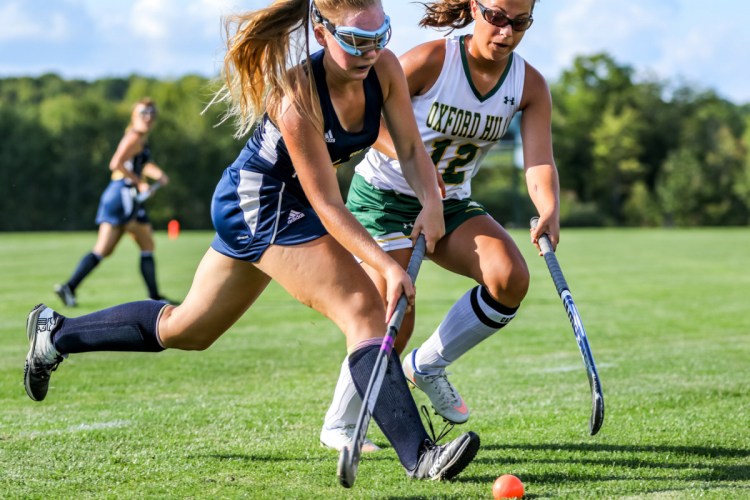 Mt. Blue's Ella Stone tries to get around Oxford Hills' Kate Bowen in first half Tuesday in South Paris.
