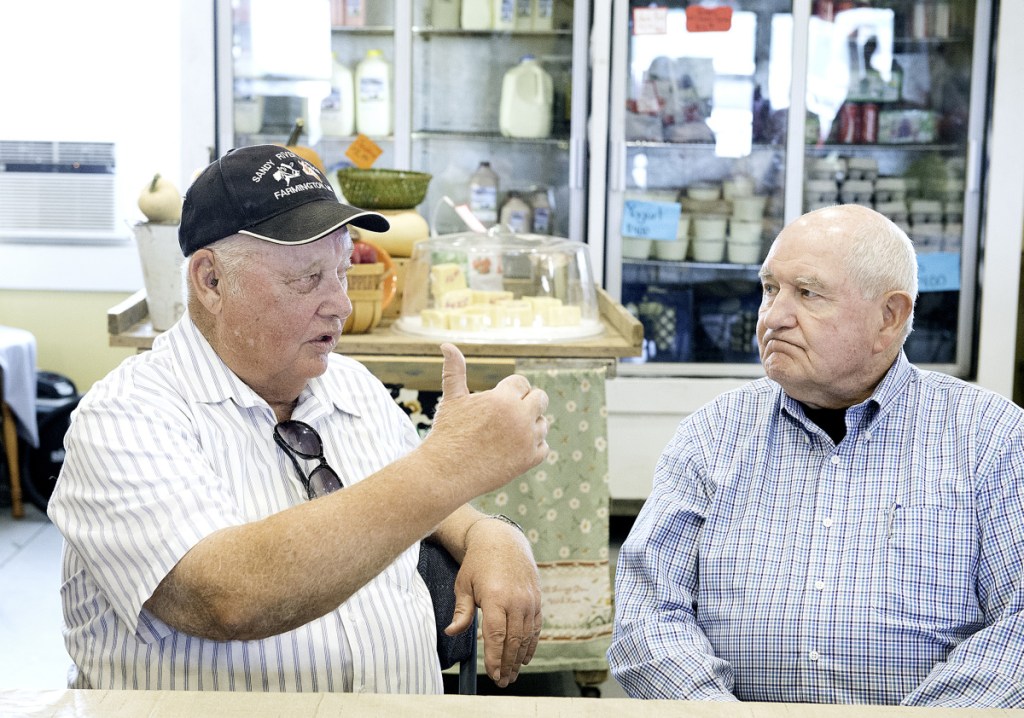 USDA Secretary Sonny Perdue, right, listens Wednesday as Bussie York explains the struggles of keeping open his family's Sandy River Farms in Farmington.