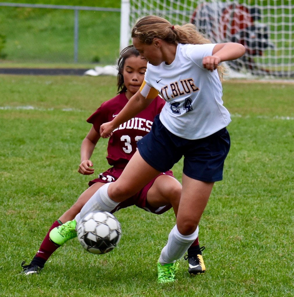 Edward Little junior forward Lydia Celani, back, and Mt. Blue senior midfielder Macey Phillips battle for the ball during a game Friday in Auburn.