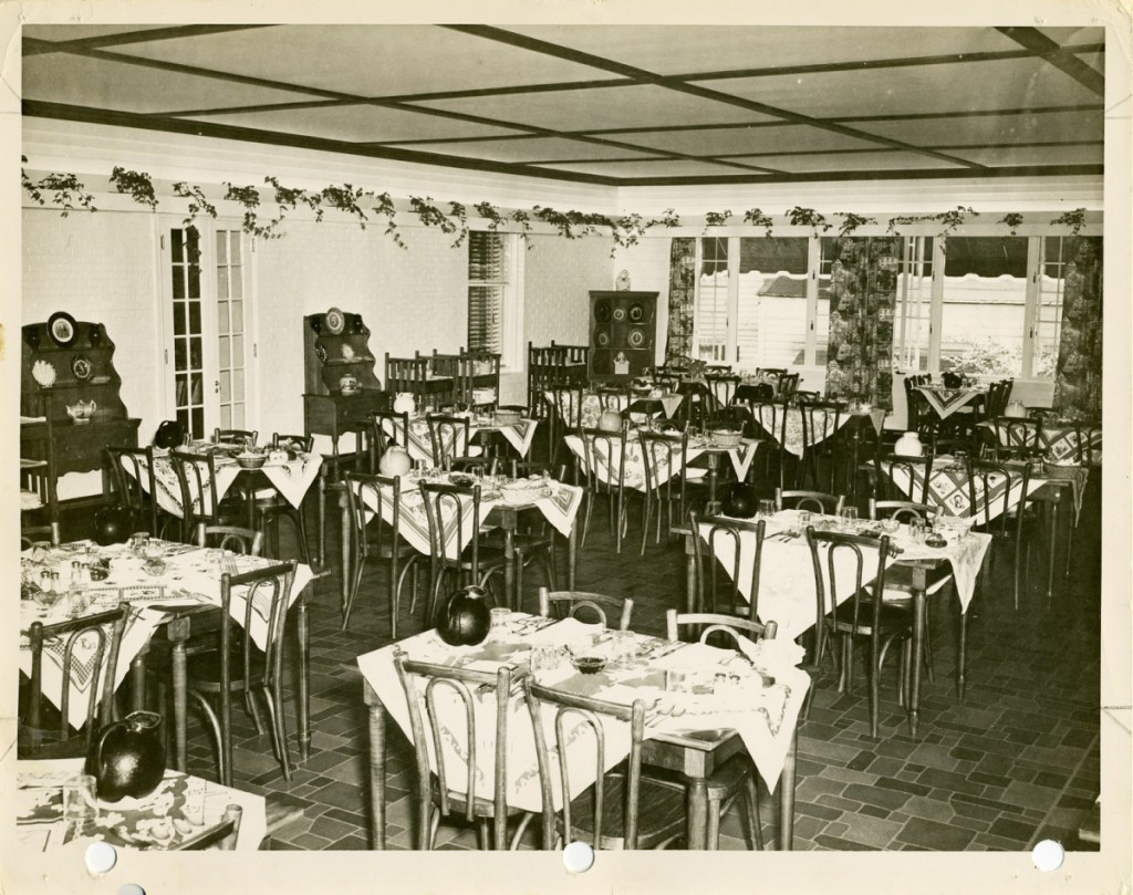 The Worster House Terrace dining room set for dinner with the windows opening to catch the summer breezes.