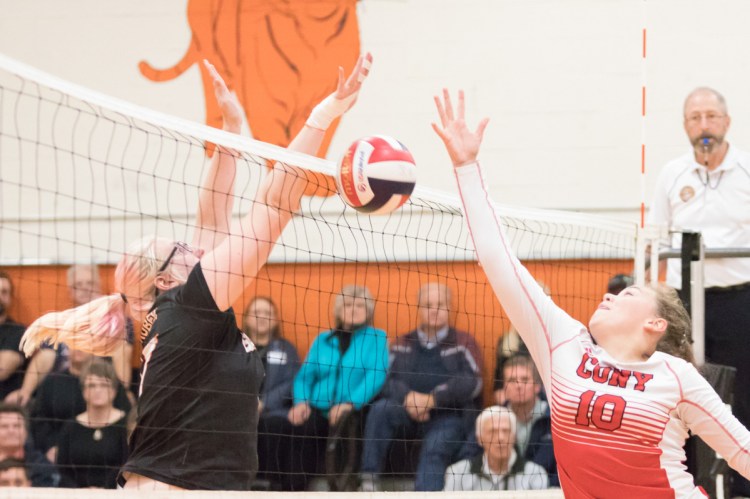 Gardiner's Ceri Gruber and Cony's Emma Levesque compete at the net during a volleyball match Tuesday night at Gardiner Area High School.