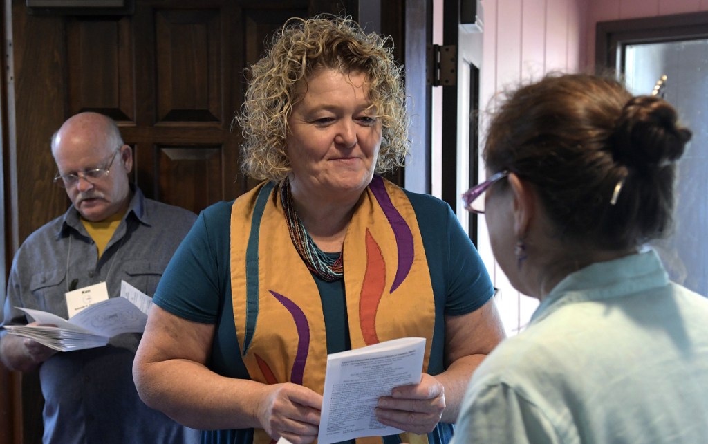 The Rev. Carie Johnsen, center, of the Unitarian Universalist Community Church in Augusta, speaks Sept. 16 with parishioners before services in Augusta. Johnsen is leaving at the end of this month for Wales, where she will serve as minister of a church there for the month of October. The Rev. Alun Dafis is coming to Augusta to minister at the UU church here throughout October.