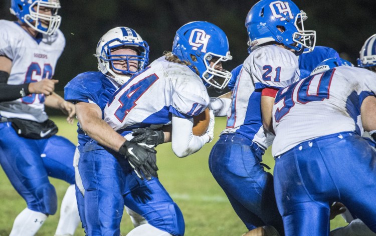 Oak Hill's Samuel Lindsay (14) gets tackled by Madison's Brad Peters in the first quarter last weekend in Madison.