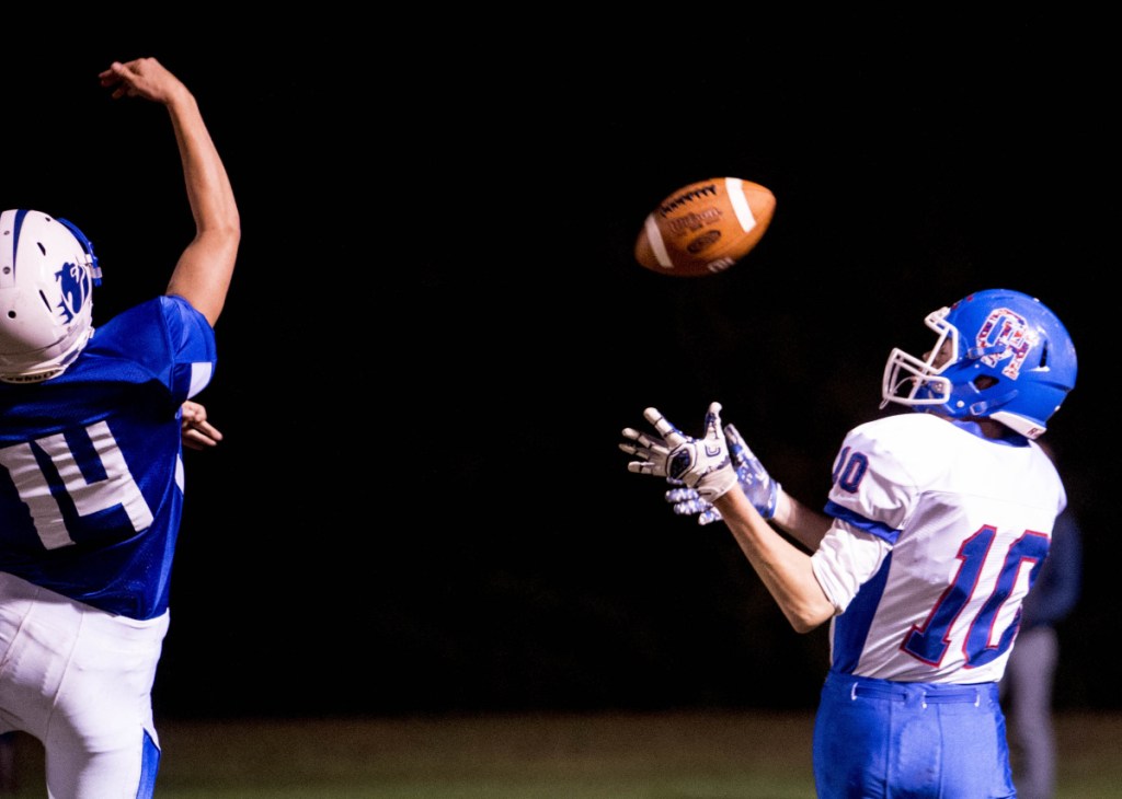 Oak Hill receiver Liam Rodriguez (10) misses a fourth down conversion pass and takes it off the helmet as he is defended by Madison's Thomas Courtney (14) Friday in Madison.