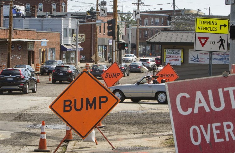 Motorists navigate road construction at Woodfords Corner in Portland recently. This weekend, work at railroad crossings will shut down a stretch of Forest Avenue, rerouting traffic onto Stevens Avenue just as Deering Center holds its annual Porchfest celebration.