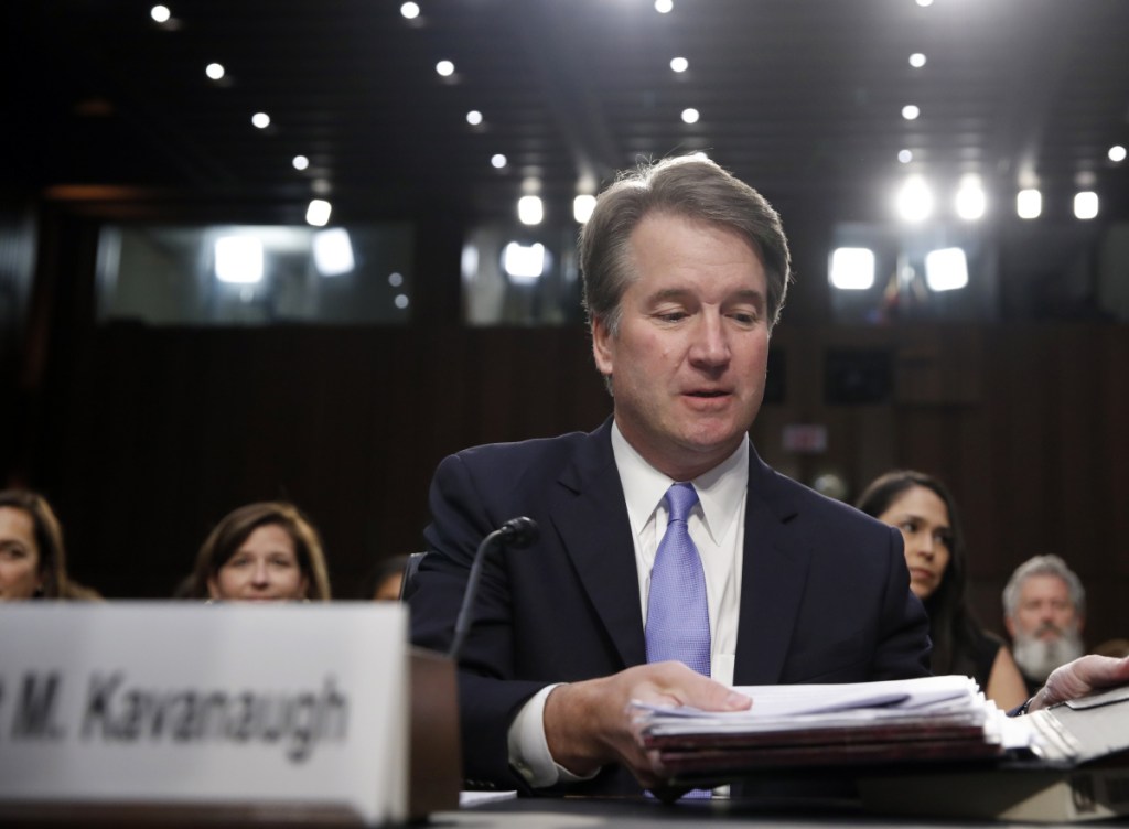 President Trump's nominee for the Supreme Court, Brett Kavanaugh, readies his papers before he testifies before the Senate Judiciary Committee.