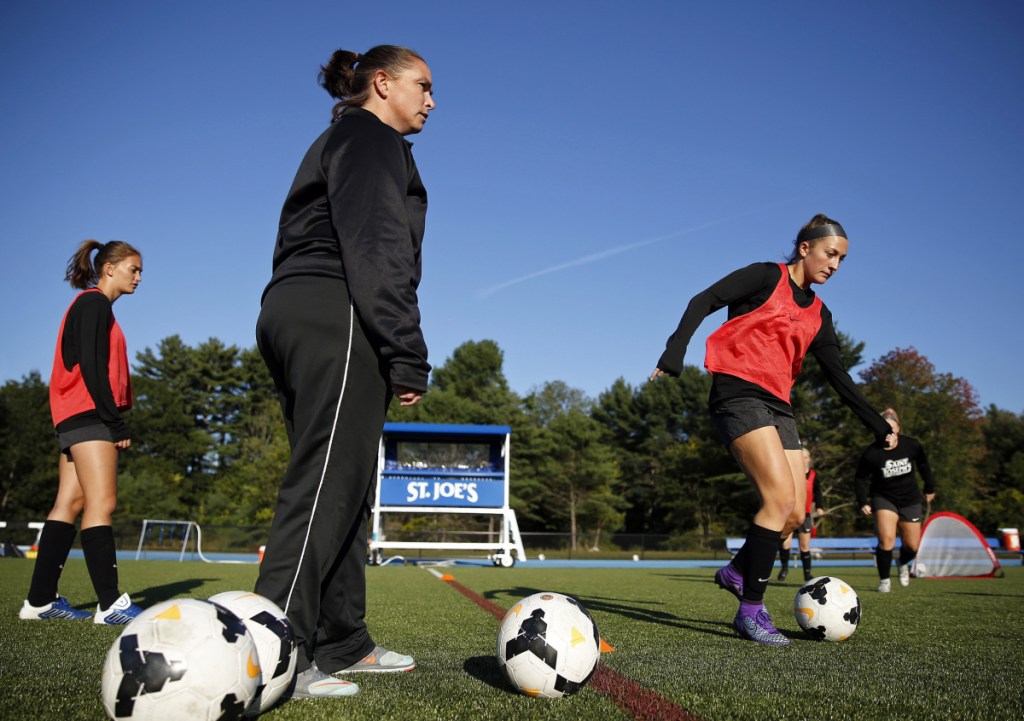 St. Joseph's women's soccer coach Jenelle Harris leads her team during a recent practice. The Monks are off to a 5-1 start and included 20 players who played high school soccer in Maine.