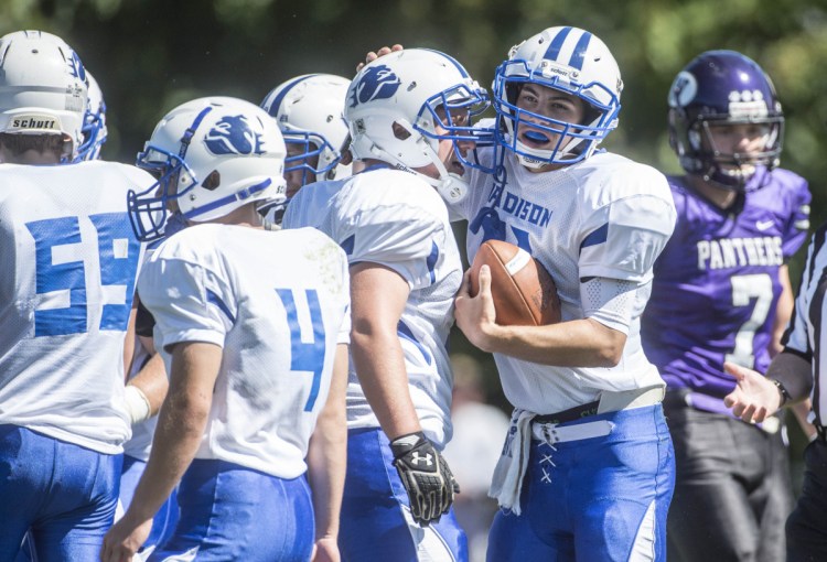 Staff photo by Michael G. Seamans 
 Madison's Eric Wescott (11) celebrates his touchdown run against Waterville with teammate Brad Peters (55) during a crossclass game Saturday at Drummond Field in Waterville.