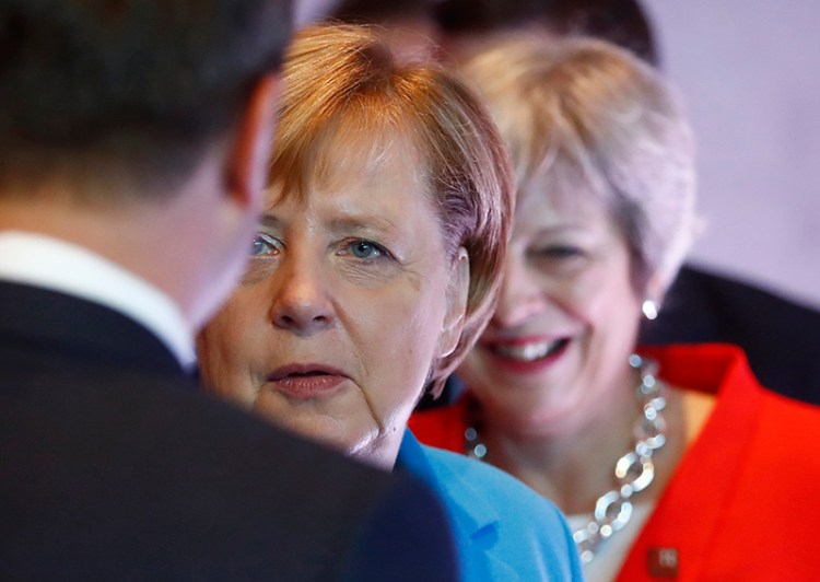 German Chancellor Angela Merkel, left, and British Prime Minister Theresa May wait for the beginning of the plenary session of the informal EU summit in Salzburg, Austria on Thursday.