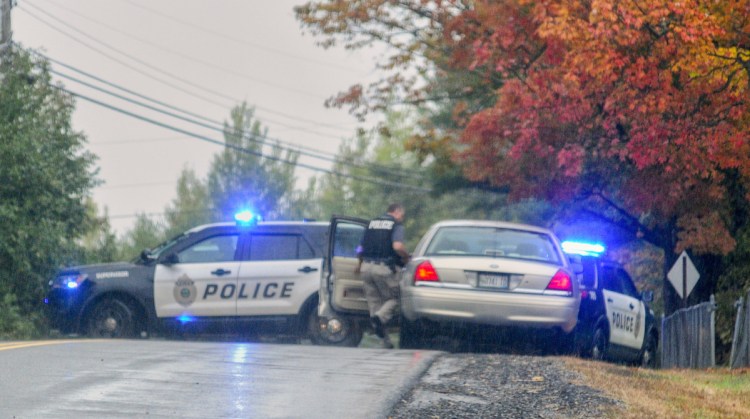 Augusta police leave the scene after making a vehicle stop Tuesday beside Coombs Mills Cemetery on Mount Vernon Road in Augusta. They stopped the vehicle in connection with an investigation into the robbery of a Subway on Bangor Street in Augusta.