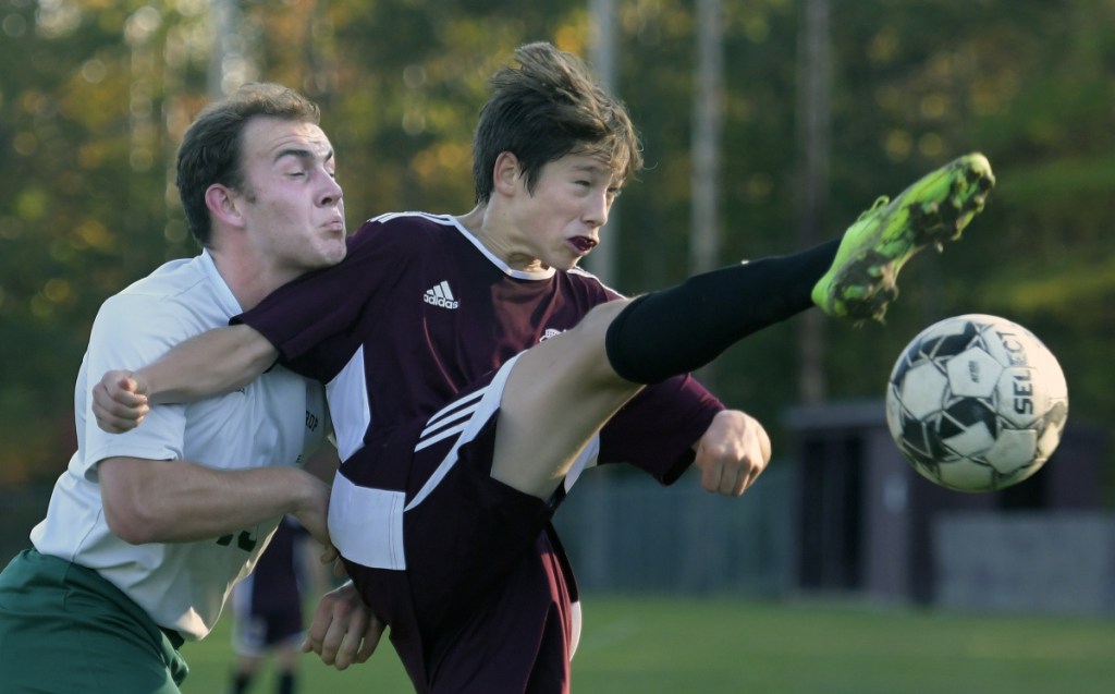 Monmouth's Cam Armstrong gets a leg up on Winthrop defender Noah Grube during a Mountain Valley Conference soccer game Tuesday in Monmouth.