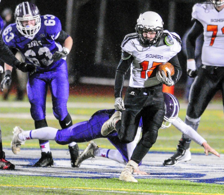 Skowhegan running back Hunter Washburn outruns Marshwood defenders during the Class B state game last season at Fitzpatrick Stadium in Portland.