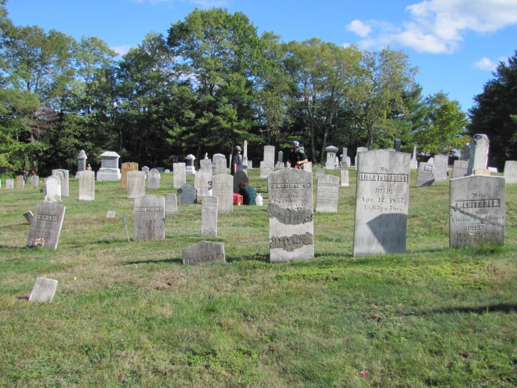 Unity College students cleaning headstones at Pond Cemetery.